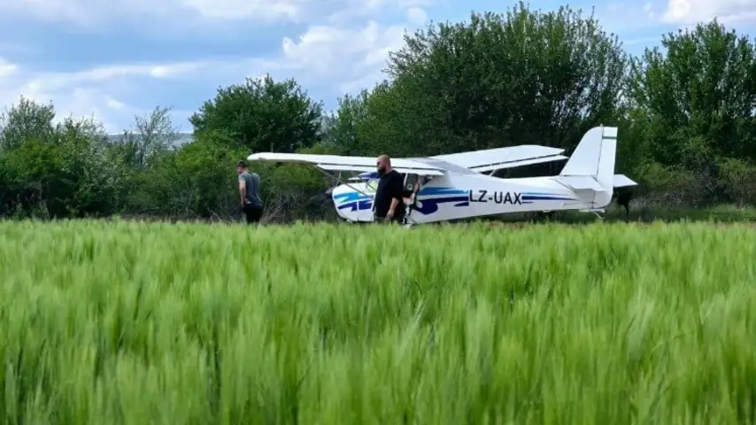 Two-seat light aircraft on a grass airfield