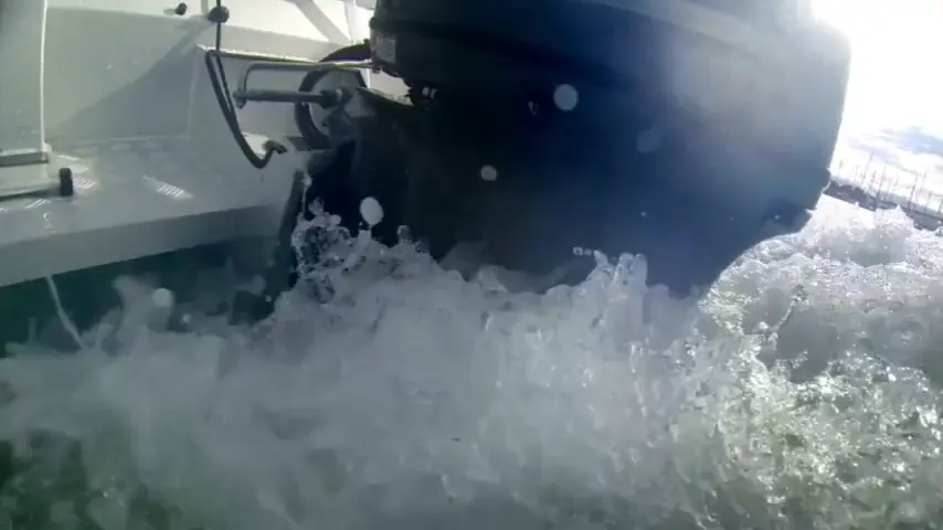 Spray from the outboard motor at speed