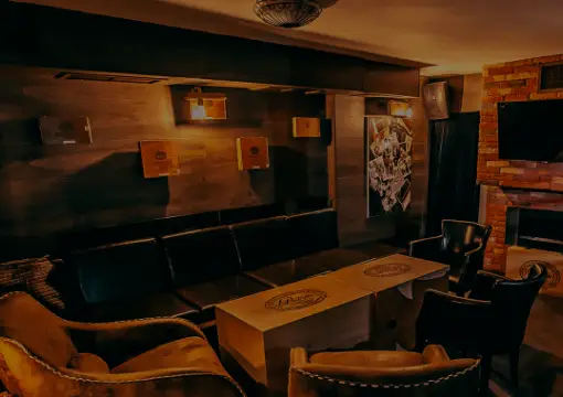 Ground floor of Bar Caldo with wooden tables and warm lighting