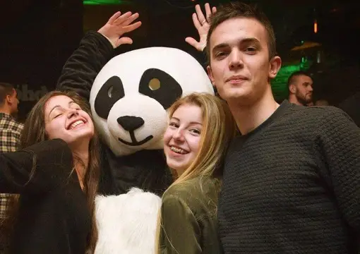 Guests with a panda mascot on a night out in Sofia