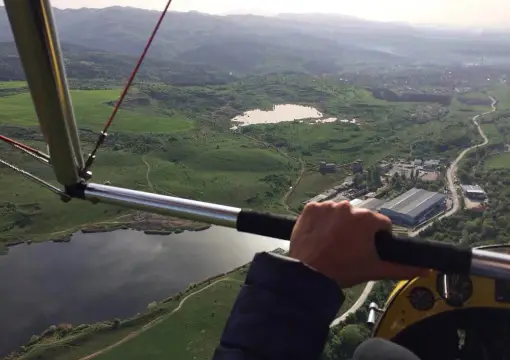 View from a motor hang glider over a lake and fields north of Sofia