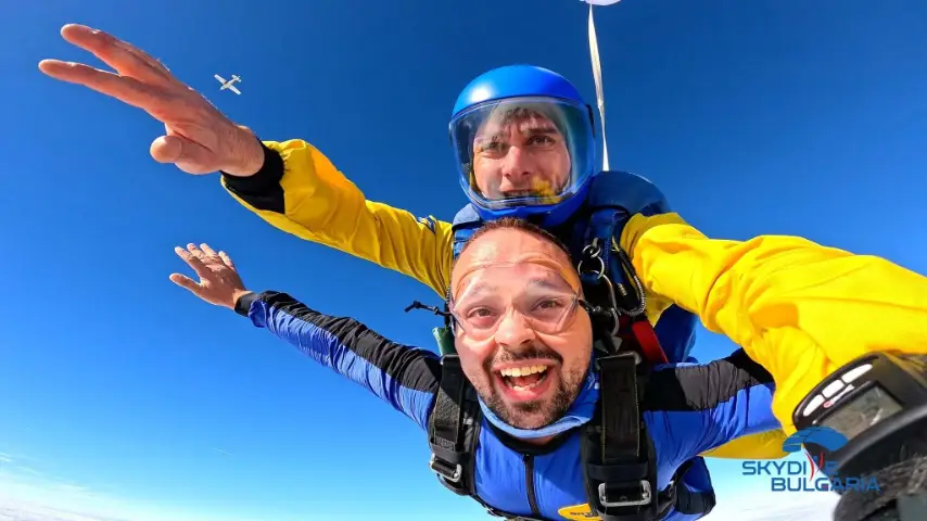 Tandem skydivers in freefall over Bulgaria