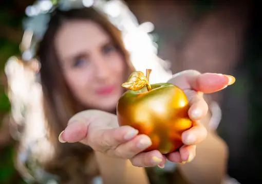 Hands holding the golden apple