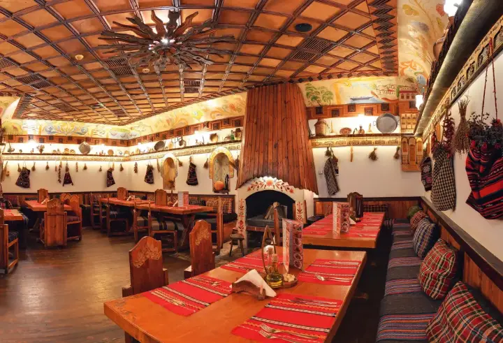 A long dining hall with an open fireplace